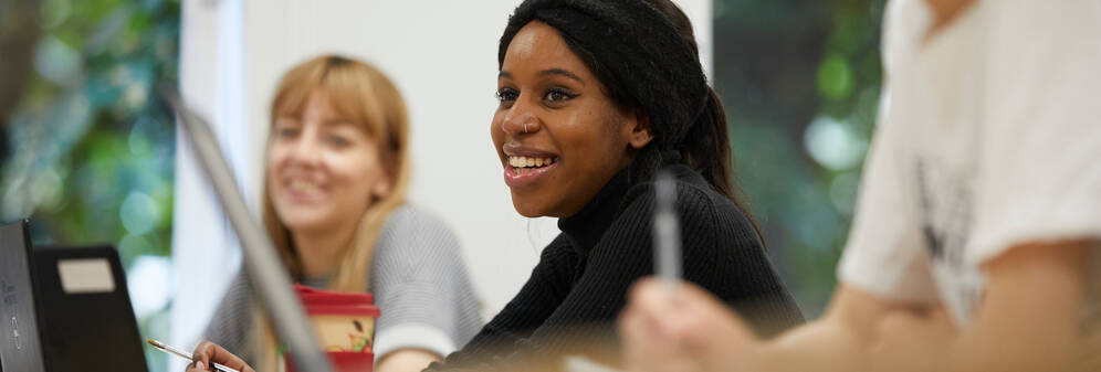 A mature student smiling in a classroom.